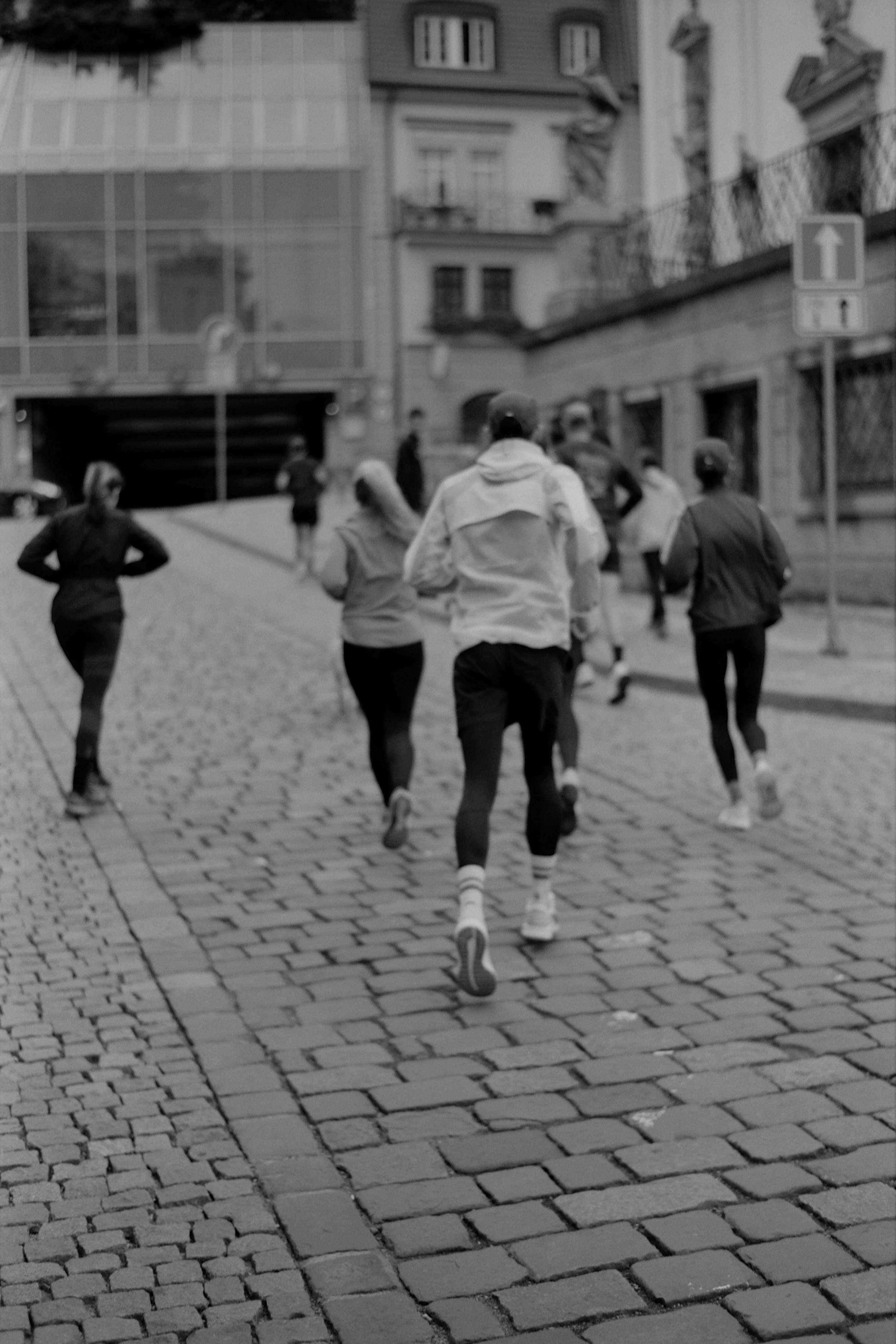 Group run along a cobblestone street